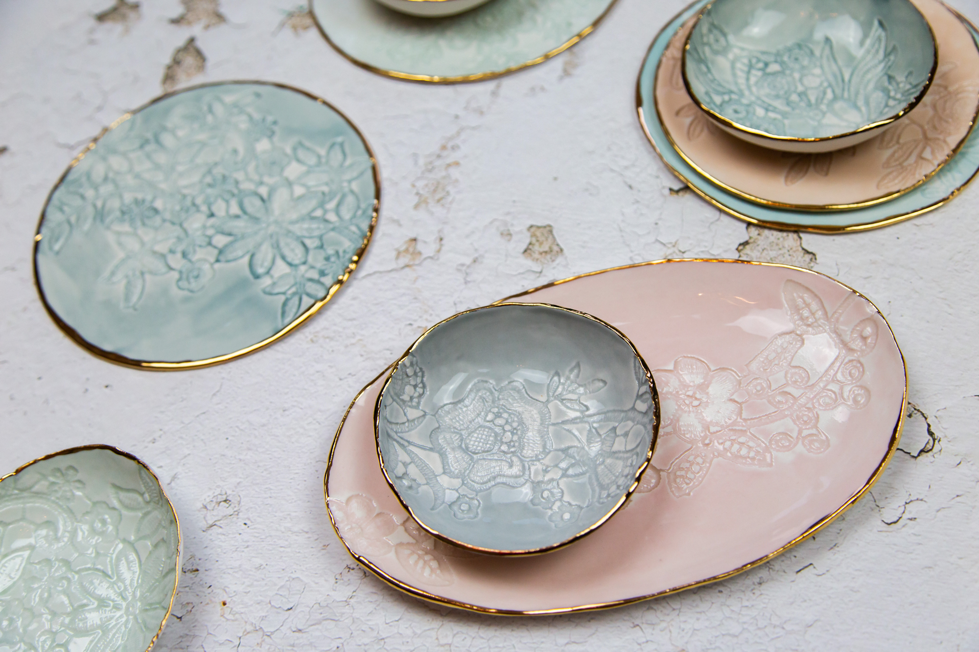 Lace Printed Plates and Bowls. Porcelain with pastel glazes and gold lustre accents. Sizes range from 14-30cm wide